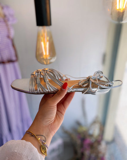 Sandálias rasa com tiras nó prateada e laçada tornozelo