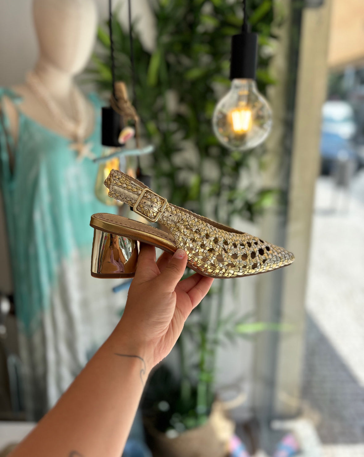 Mule trenzado dorado con tacón y hebilla