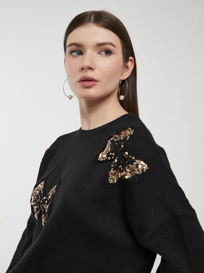 Camisola preta com laços e lantejoulas